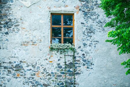 Rope wooden stairs on white building brick wall with window and flowers outdoor on fairy backgroundの写真素材