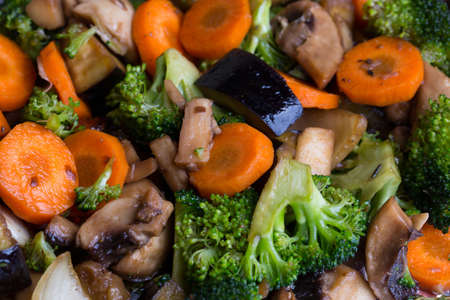 Cooked vegetables and champignons mix on vegetarian backgroundの写真素材