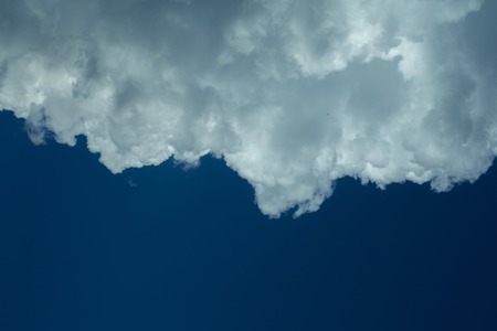 Big white fluffy cloud on blue sky background, copy space