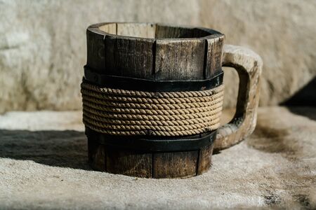 Close up of wooden mug with thread decor for a nice drinkの写真素材