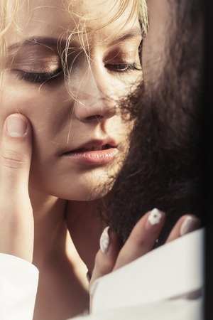 young sexy couple of pretty woman with blonde wet hair and bearded man with long beard embracing...