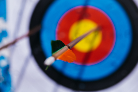 Modern arrow with plastic fletchings hit target archery ring on backgroundの写真素材