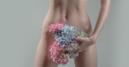 young pretty woman with naked sexy slim wet body and naked belly holding hydrangea flower bouquet in hands on studio grey background, copy spaceの写真素材