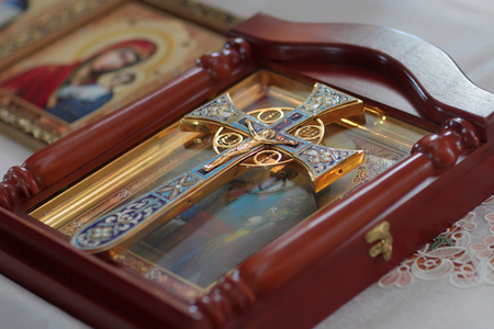 Ukraine, Kyiv - June 24, 2016: golden christian cross on icon with holy image on blurred backgroundのeditorial素材