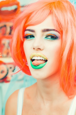Young girl with pretty face bright professional makeup colorful eyeshadow yellow and green lips and...