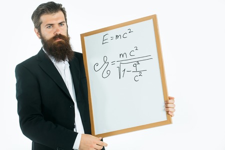 young handsome bearded man scientist or professor with long beard holding teacher board with einstein formula and newtons law isolated on white backgroundの写真素材