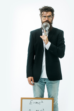 young handsome bearded man scientist or professor in glasses with long beard holding teacher board...
