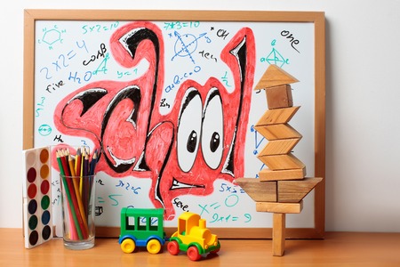 school text word painted graffiti with smiley eyes math equations and formulas on paper near...