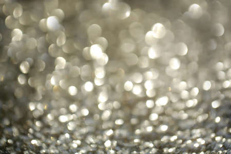 sparkling abstract bokeh defocused blurred background silver color with glitter circles and no peopleの写真素材
