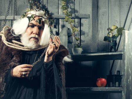 Zeus god or jupiter in rope with vine crown in studioの写真素材