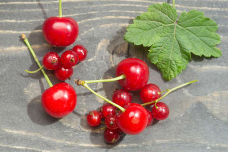 Red ripe berries on the wooden surface