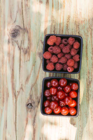 Two bowls of red berries. Healthy sneck for the summer breackfastの写真素材