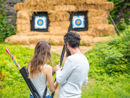 Couple with bow and arrows is ready to shootの写真素材