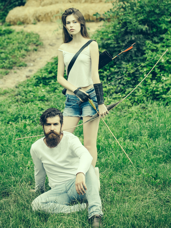 Attractive girl is ready to shoot and handsome man sits nearの写真素材