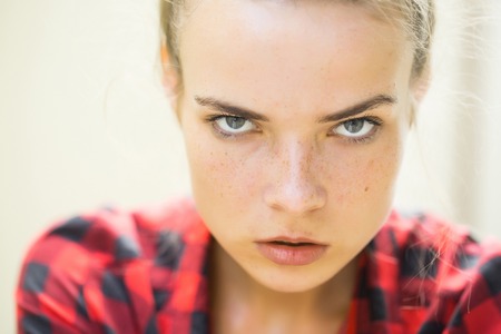 freckles woman portrait with gray eyes in checkered shirt outdoorの写真素材
