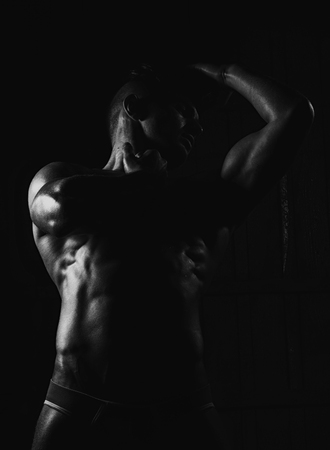 Muscular young man with athletic bare body standing, black and whiteの写真素材