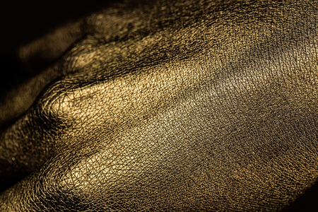 female golden or gold hand or arm with palm and fingers with body art painted metallized color, closeupの写真素材