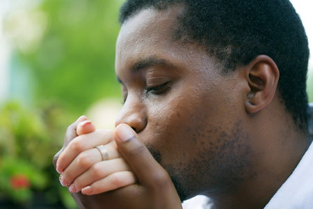 Handsome man african American groom husband kisses hand of bride caucasian woman on wedding ceremonyの写真素材
