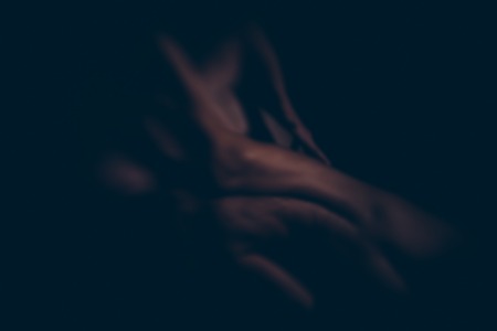 blurred or defocused young sexy couple of pretty slim naked woman with slim body and cute buttocks touched by handsome muscular man in studioの写真素材