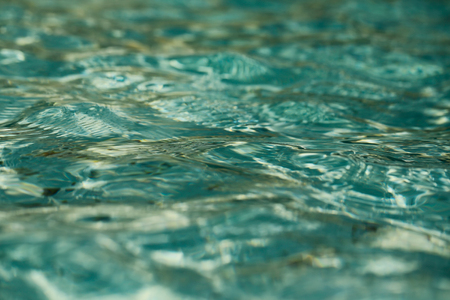 clear transparent water in swimming pool sea or ocean blue or turquoise color as natural textured...