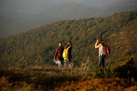 handsome bearded man in checkered shirt with pretty young cute girls or women smiling and walking...
