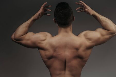 young handsome macho man bodybuilder with sexy muscular athletic body with bare torso and strong...