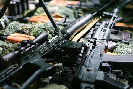 War guns arsenal modern military assault rifles shotgun weapon arms outdoors on natural background