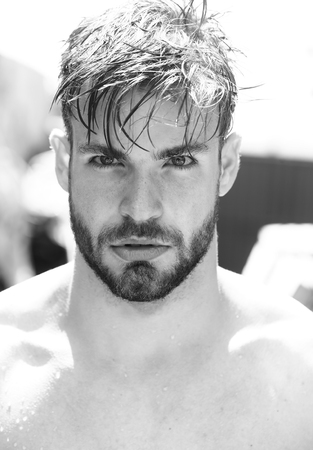 Handsome bearded man young guy male with beard and wet hair outdoors on sunny day black and whiteの写真素材