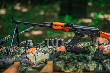 War guns arsenal modern military assault rifles shotgun weapon arms outdoors on natural backgroundの写真素材