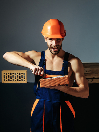 young handsome bearded macho man smiling builder with sexy muscular athletic strong body has strong...