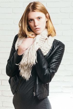 young pretty woman or fashionable sexy girl with cute face and blonde hair in scarf and leather...