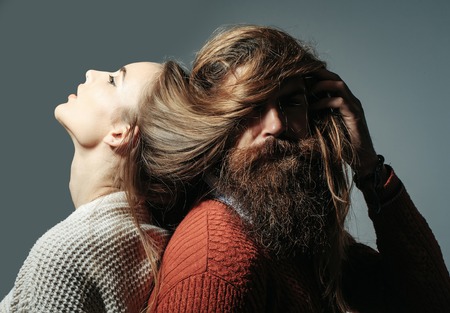 Young couple of pretty girl or beautiful sexy woman with long messy hair on head and face of bearded...