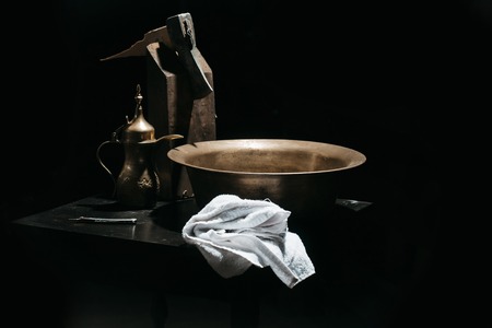 Vintage barber or shaver tools on wooden table. Old razor with blade, copper basin, water jug, axe and towel in barbershop or hairdressing saloonの写真素材