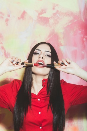 sexy cute woman or pretty girl with brunette long hair and red lipstick on lips in fashionable shirt...