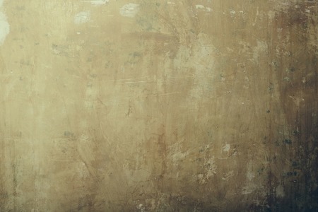 Abstract old texture wall of stained stucco surface, grunge, interior, cement mural on beige plastered backgroundの写真素材