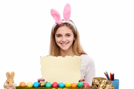 happy easter girl in pink bunny ears with golden, colorful painted eggs, rabbit, pencil, burnt paper...