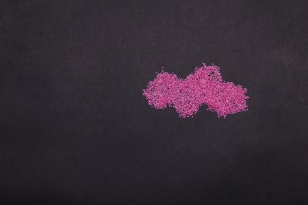 tasty pink sprinkles sweets with birthday cake candles in shape of cloud on grey background, copy spaceの写真素材