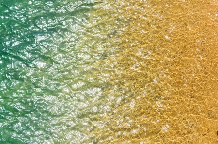 traveling, vacation, healthy environment and swimming,shining green and yellow water in pool, sea or ocean, transparent aqua texture, surface with ripples on idyllic, sunny, summer day on reflecting background.の写真素材