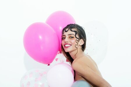 Happy pretty girl or sexy woman with cute, curly lock, blond hair, fashion hairstyle, and rosy lips,...