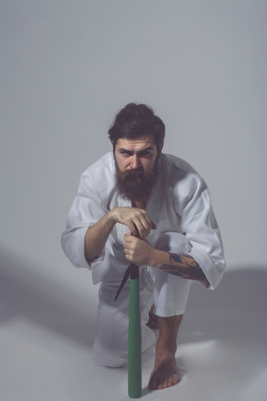 bearded karate man, long beard, brutal caucasian hipster with moustache in white kimono with black...