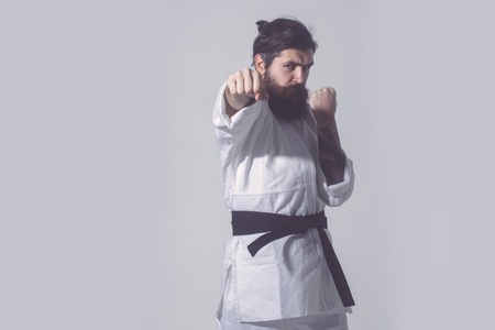 bearded karate man, long beard, brutal caucasian hipster with moustache in white kimono with black...