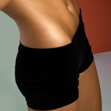 beautiful young woman with sexy slim tanned torsoの写真素材