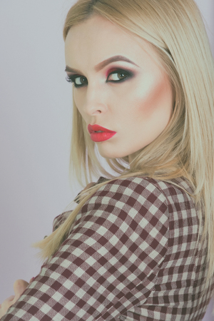 makeup. sensual glamour beautiful woman model with makeup has red lips in fashionable coat or jacketの写真素材