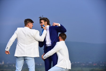 businesspeople have competition, businessman and business office team in white outfit fighting outdoor, interest conflict of colleague on blue sky backgroundの写真素材