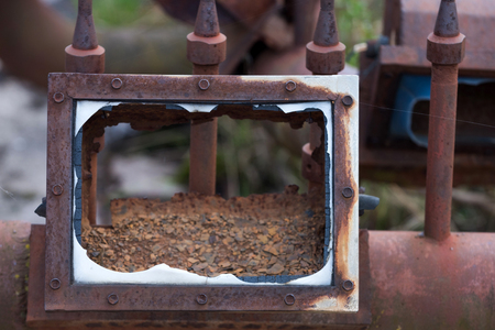 Broken rusted frame and pipe lines scrap, with metallic, rusty surface texture, outdoors on blurred background. Neglect, decay and ruinの写真素材