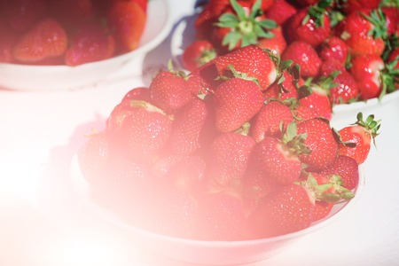 fresh red strawberry in plates on table, summer harvest, fruit and vitamin, healthy eating and dietingの写真素材