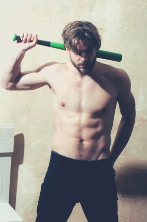 Sexy man athlete with green baseball bat in muscular hands. Sport, training, fitnessの写真素材