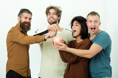 group of friends or people, cute woman or pretty girl and three men in casual wear pointing at dollars money in piggy bank on white background. Savings, budget, finance, cash and moneyboxの写真素材