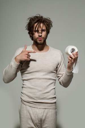 Hygiene and sanitary. Guy in underwear in morning presenting product. Sterility and purity. WC and restroom. Man show toilet paper.の写真素材