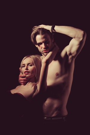 Love and romance. Couple in love of sexy man and woman. Man with muscular body with sexy girl. Relations of girl and guy. Boyfriend and girlfriend on black.の写真素材